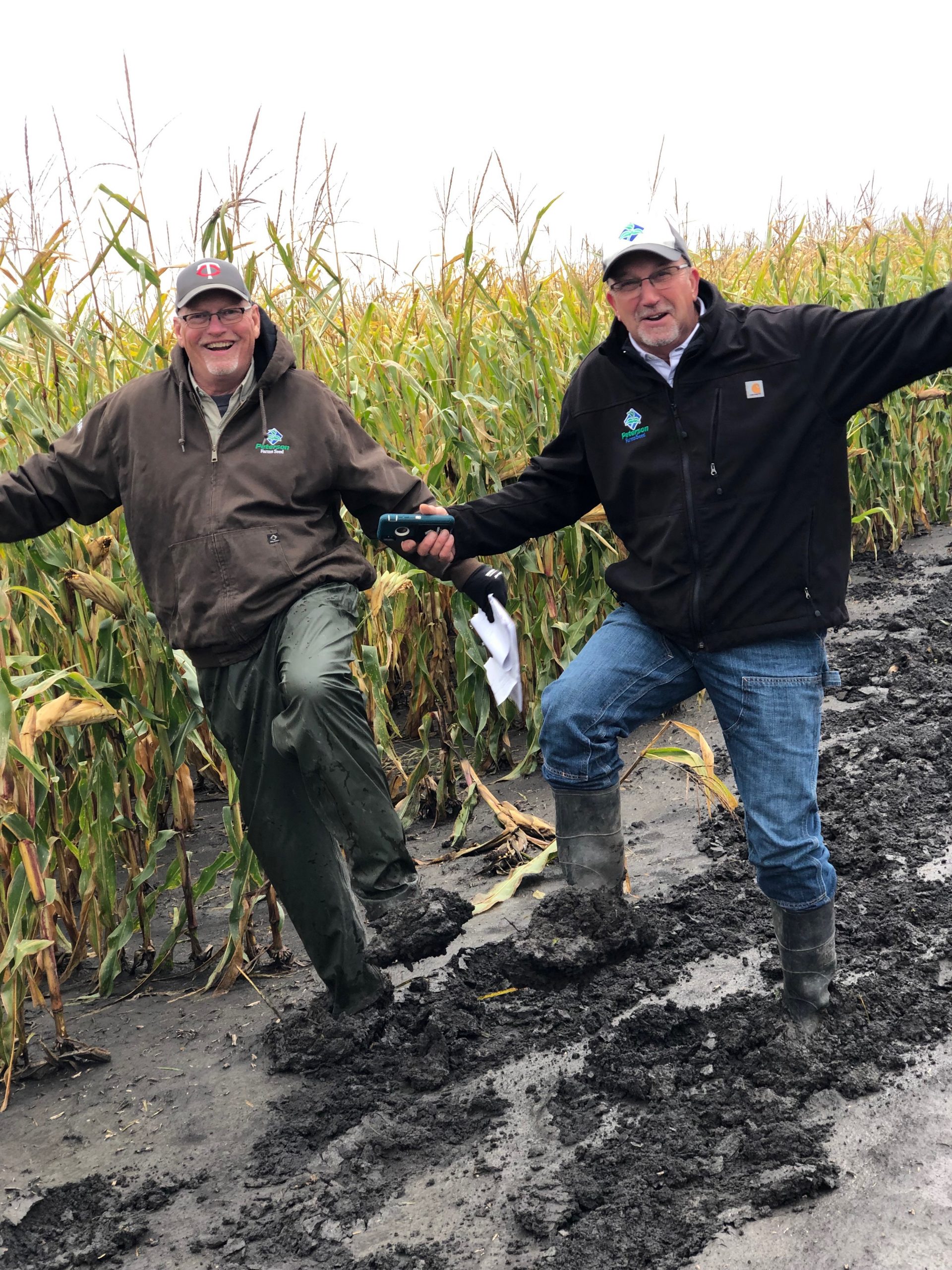 Mike and Dennis putting in the muddy corn.