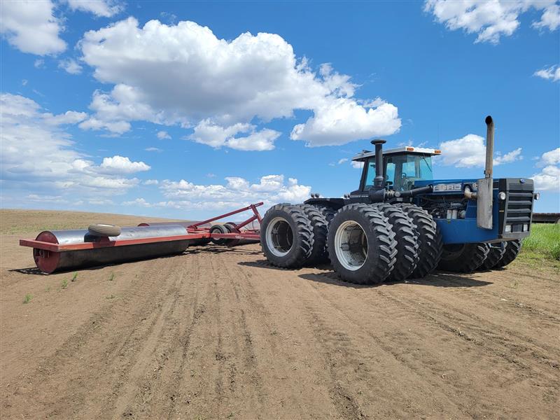 Tractor rolling soybeans